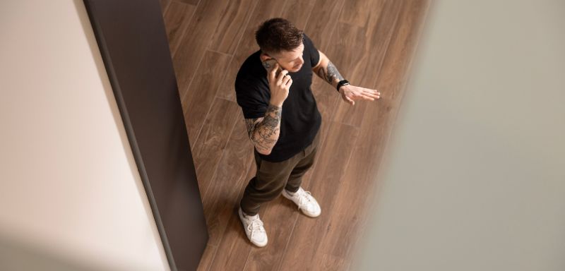 Man standing in the room and talking on the phone