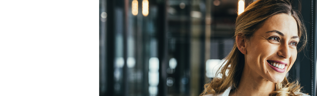 Young business woman looking through window