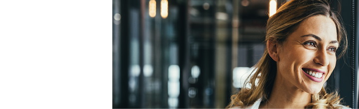 Young business woman looking through window